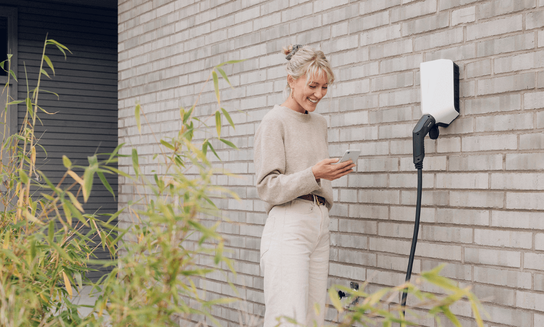 Woman at charge point mounted on wall