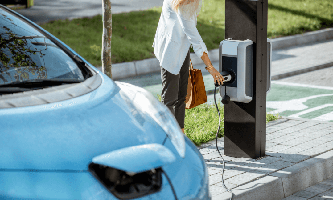 Woman charging EV in carpark